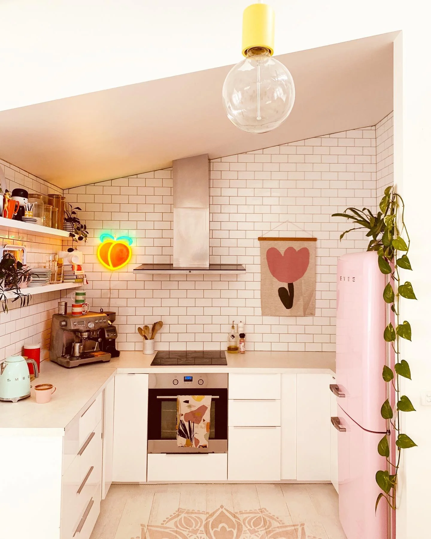 Neon Peach Sign Adds Playful Pop to White Subway Tile