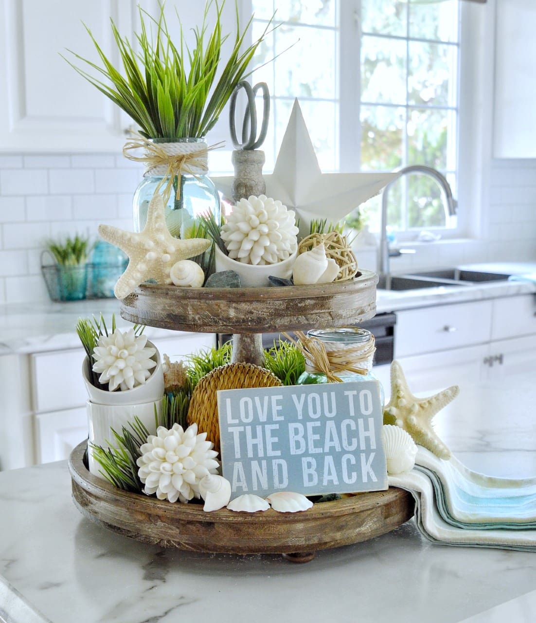 Tiered Tray With Coastal Decor Creates A Beachy Kitchen Vignette