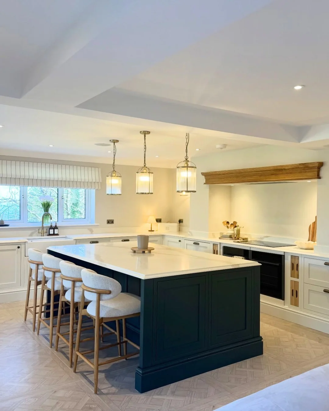 Deep Teal Island with Paneled Detail Anchors Light Grey Kitchen