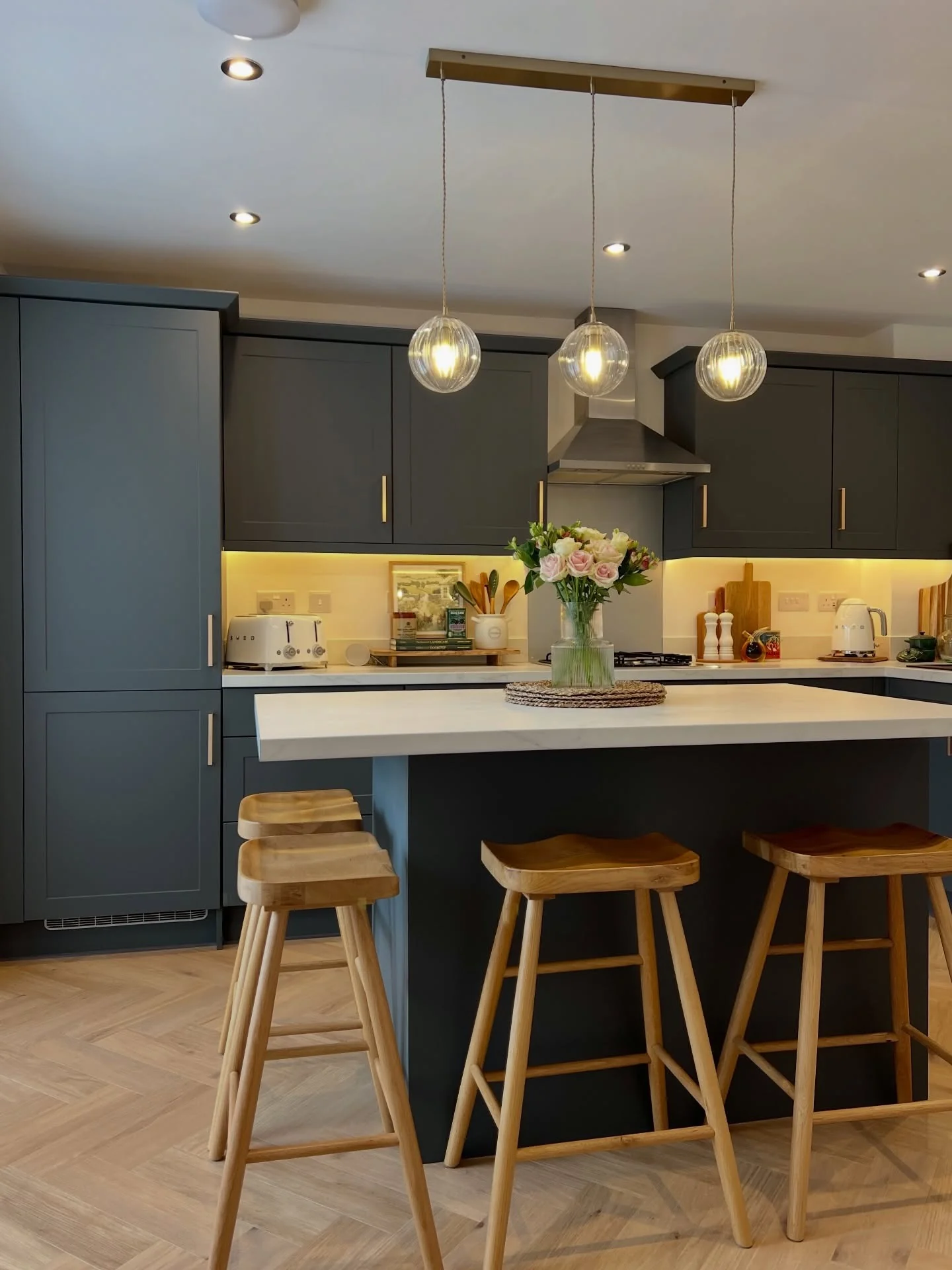 Glass Globe Pendants Add Warm Lighting Over the Island
