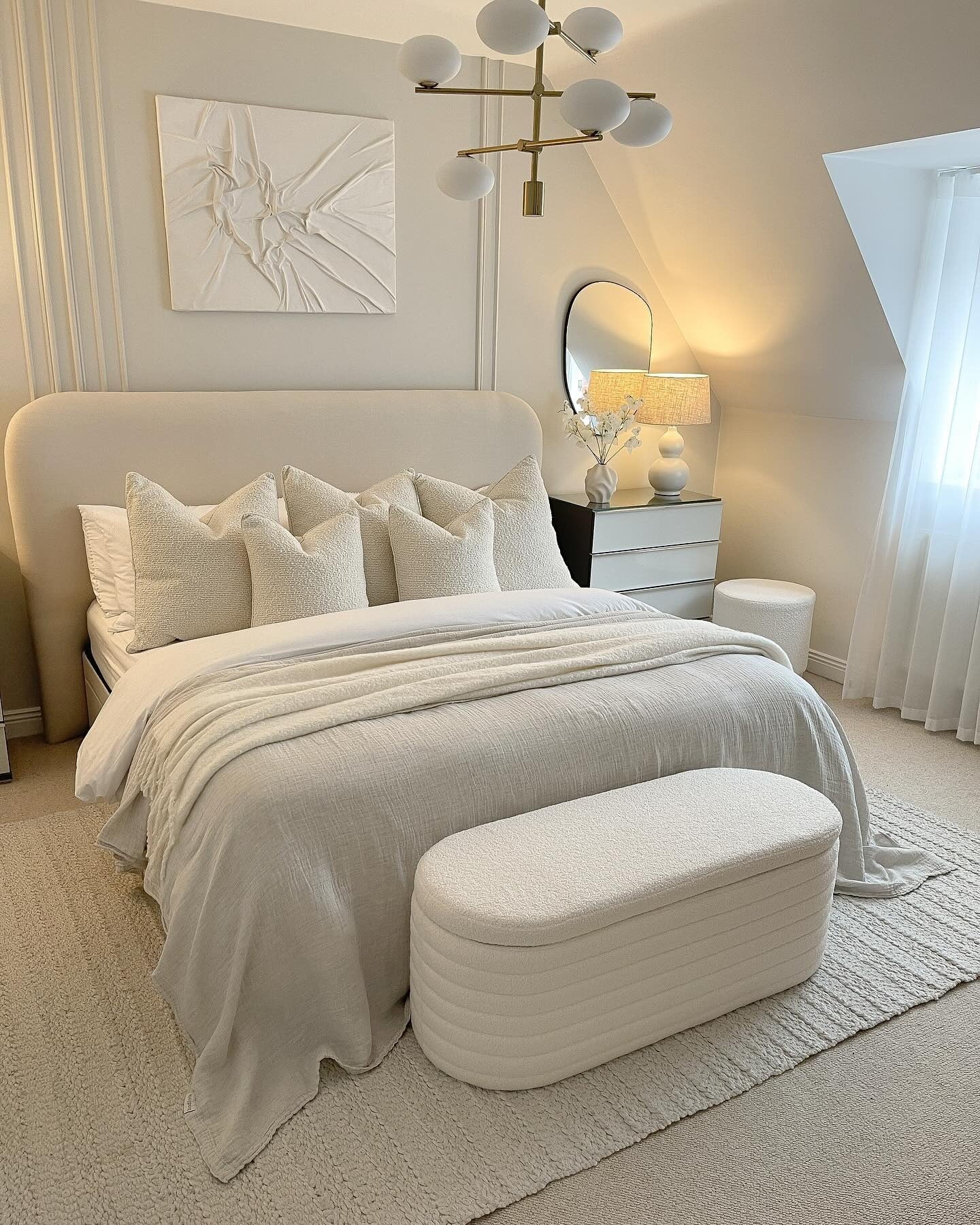Textured boucle bench adds cozy seating at the foot of the bed