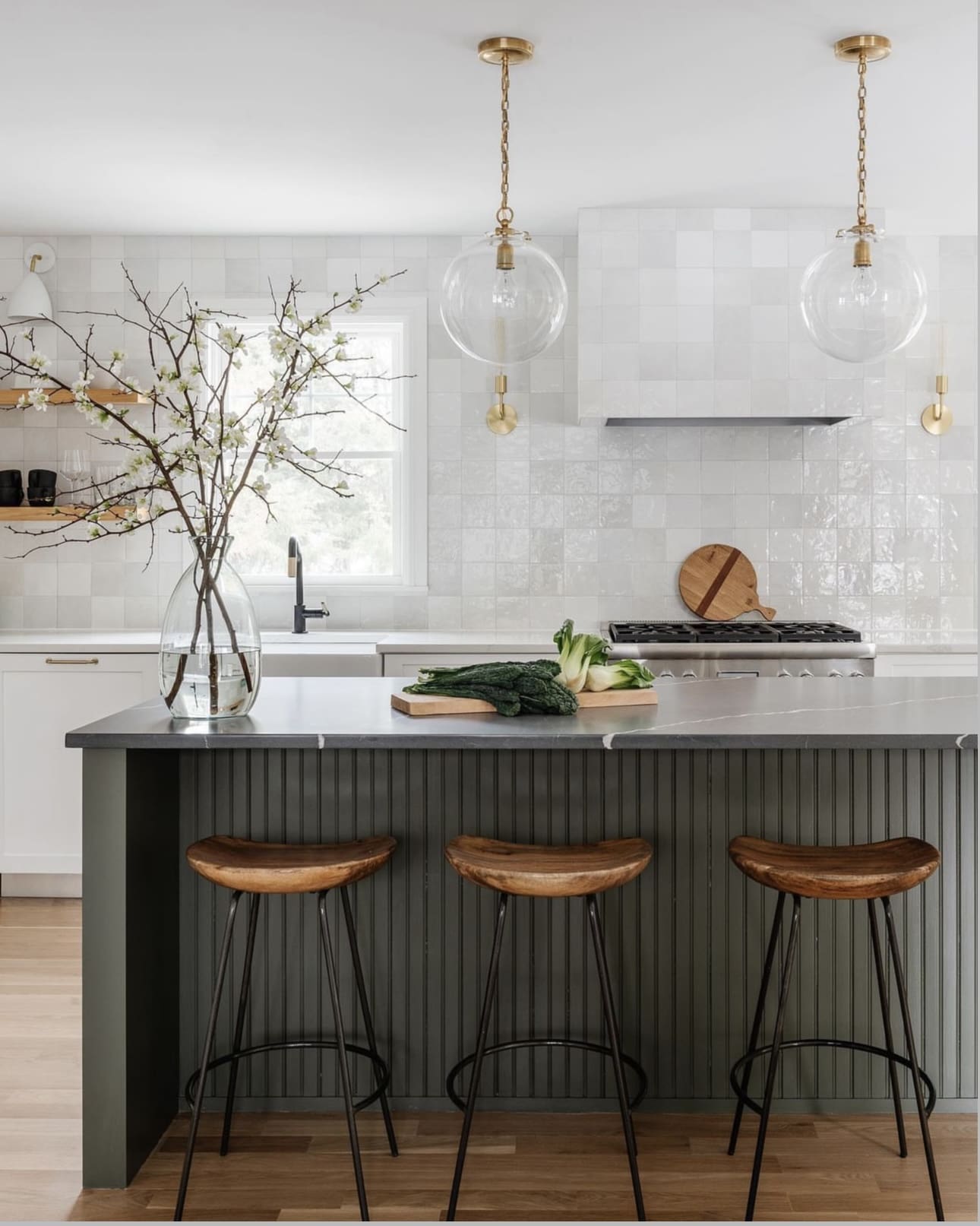 Tall Glass Vase Holds Delicate Branches Above Island