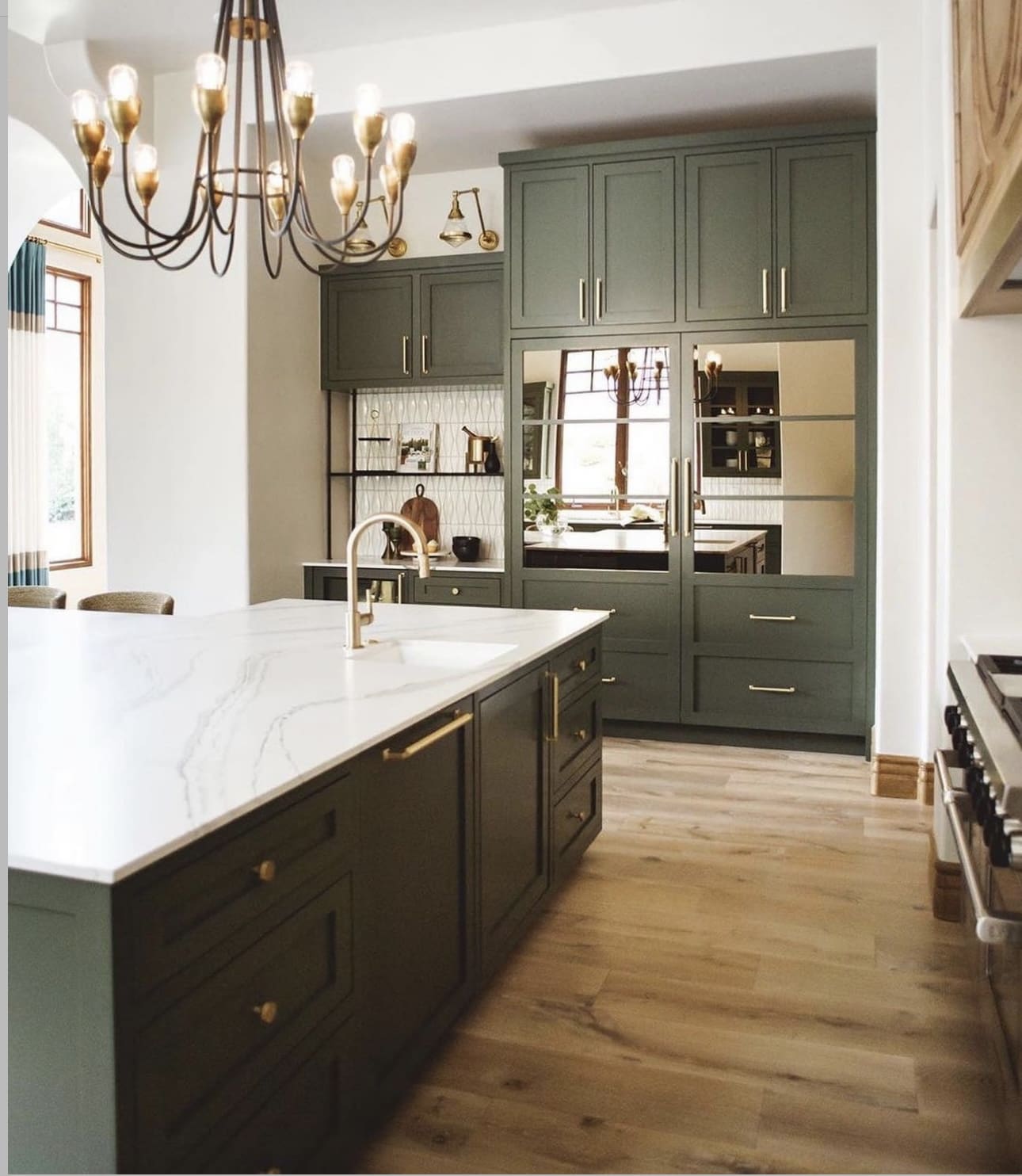 Dark Green Cabinetry With Mirrored Doors Creates Depth