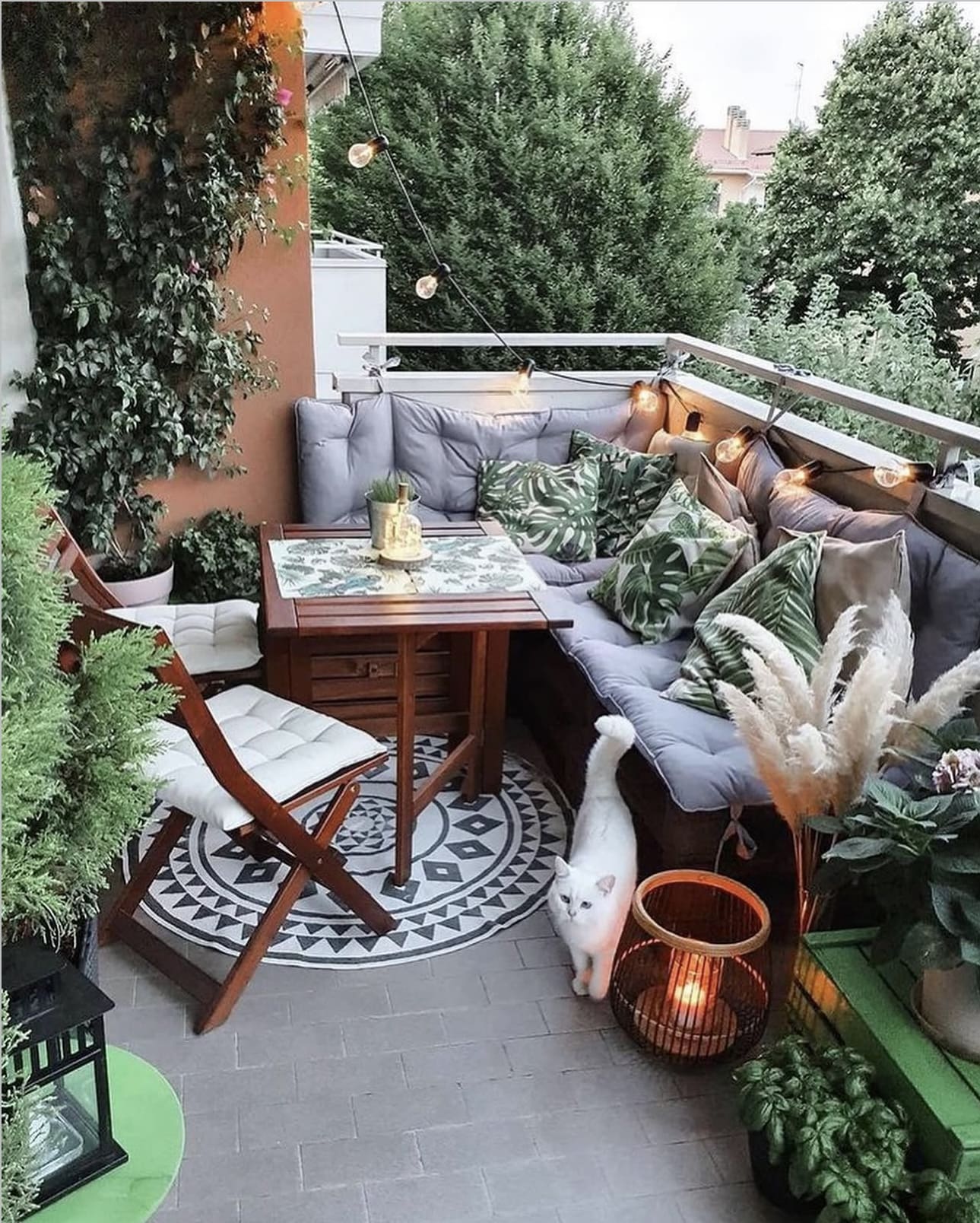 Bohemian Balcony Seating With Tropical Leaf Pillows