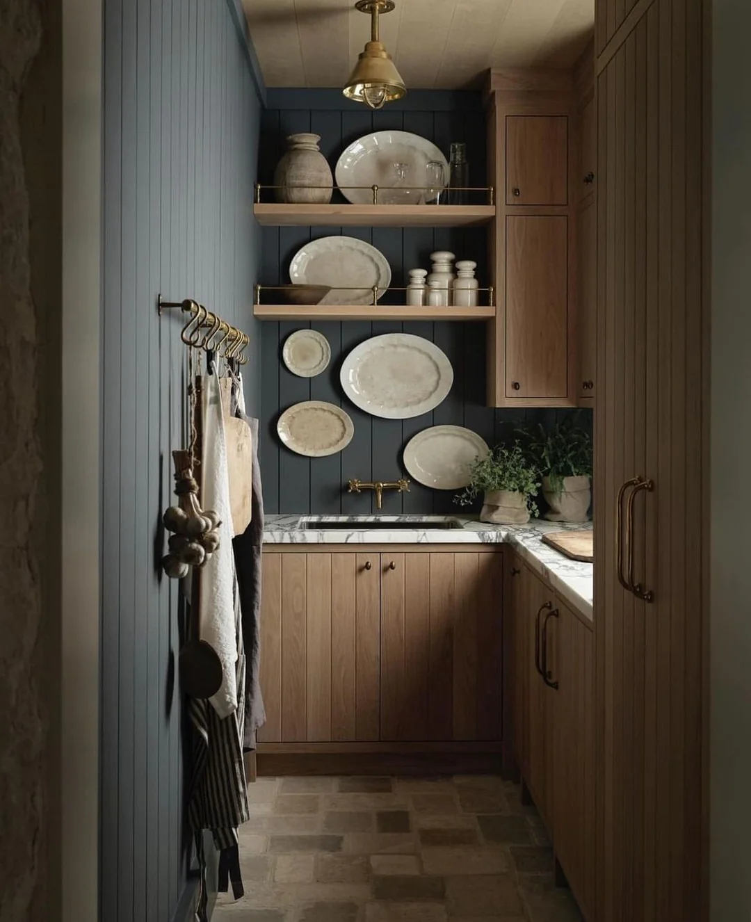 Open Shelving With Brass Rails Displays Oval Platters