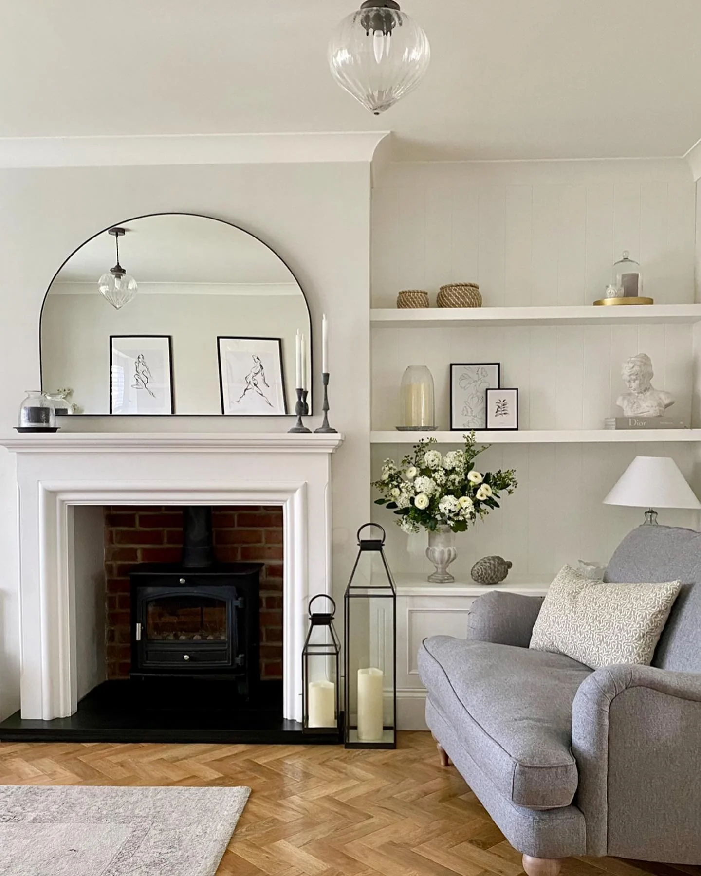 Frame Your Fireplace with an Arched Mirror and Minimalist Art