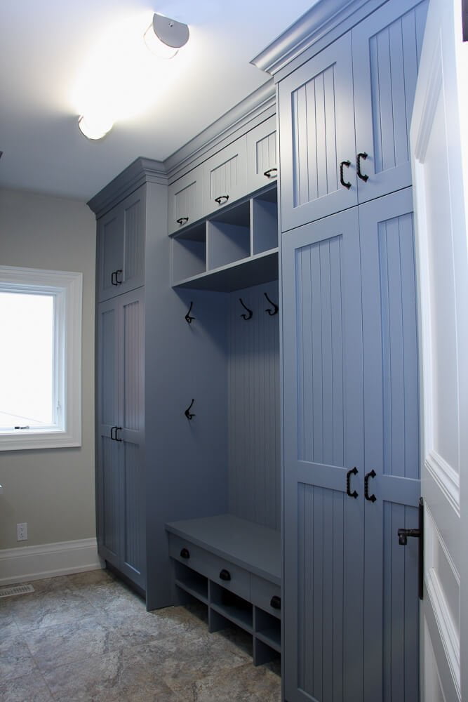 Tall beadboard cabinet doors hide clutter behind a classic look