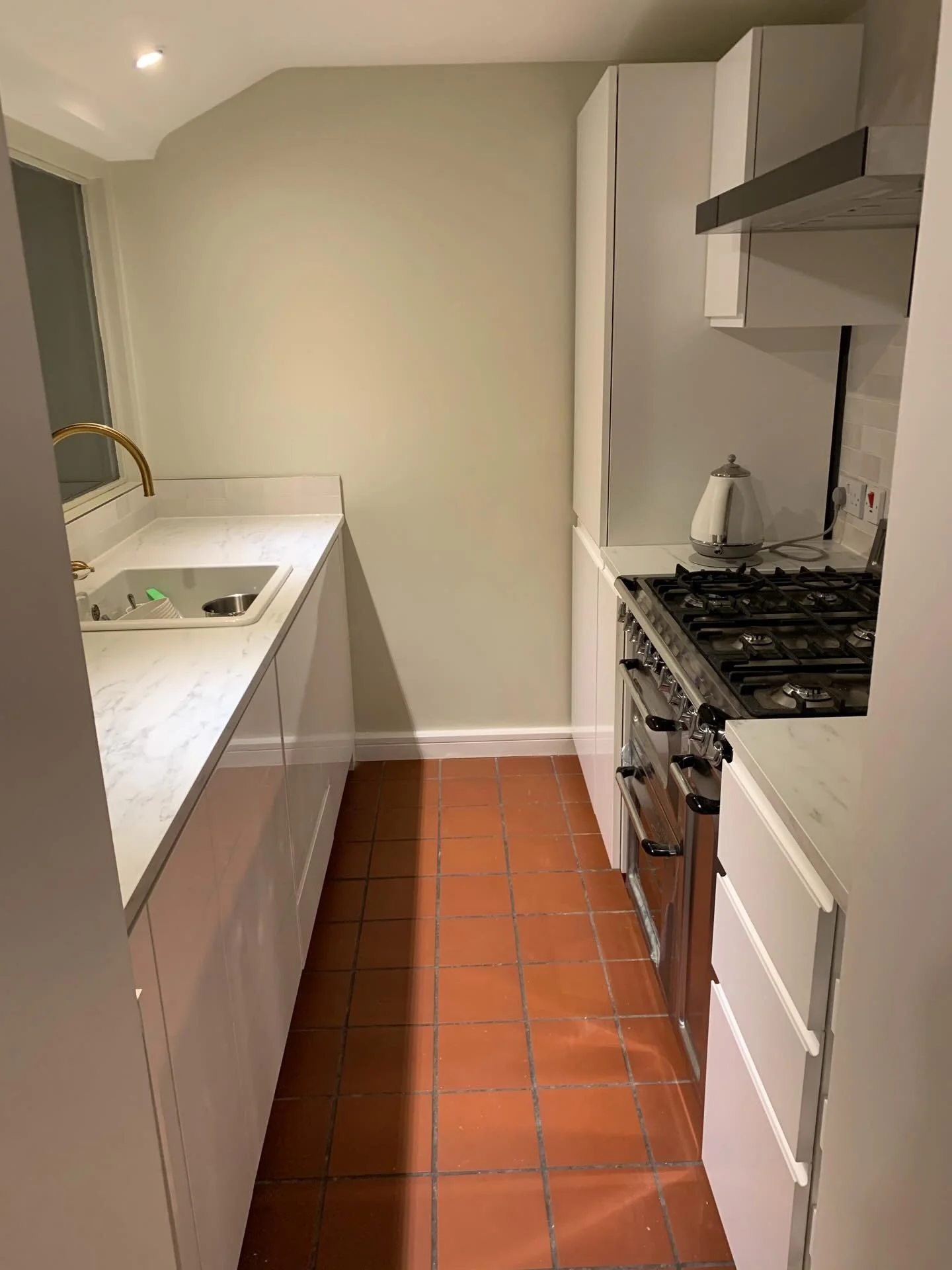 Square terracotta tiles anchor the space with earthy warmth