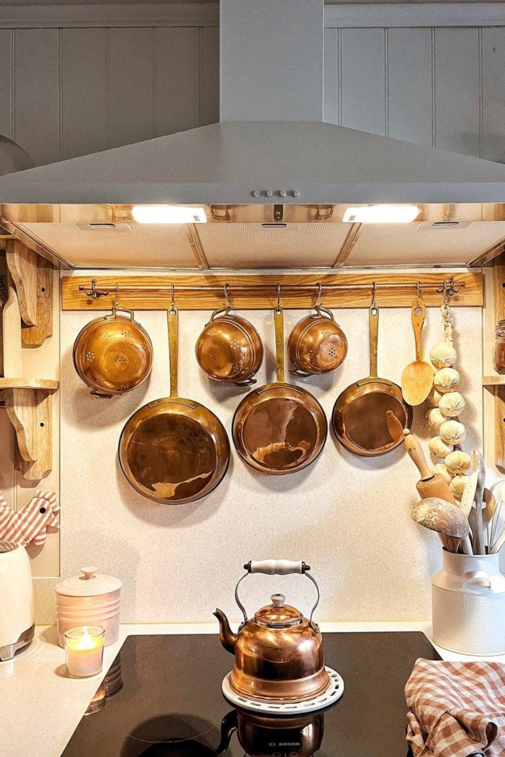Copper Pots and Pans Hung Above the Stove