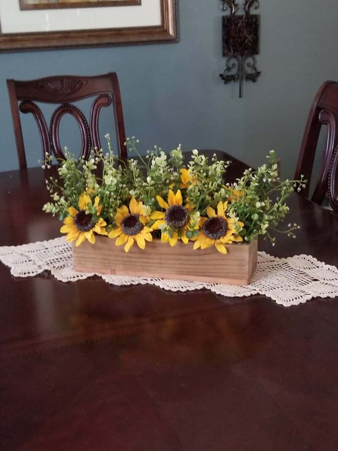 Wooden Planter Box Filled With Sunflowers and Greenery