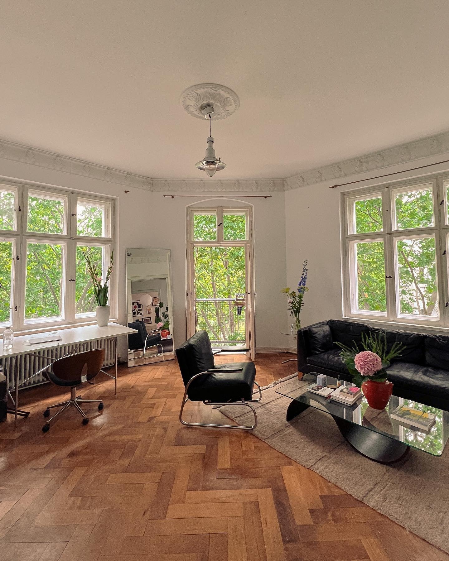 Sleek Black Sofa Contrasts Beautifully with Wood Floors
