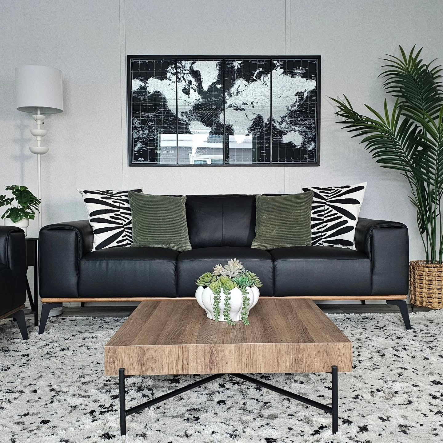 Black Sofa With A World Map Statement