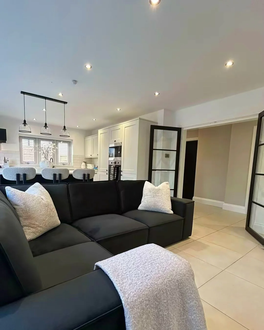 Plush Textured Pillows Enhance a Black Sectional