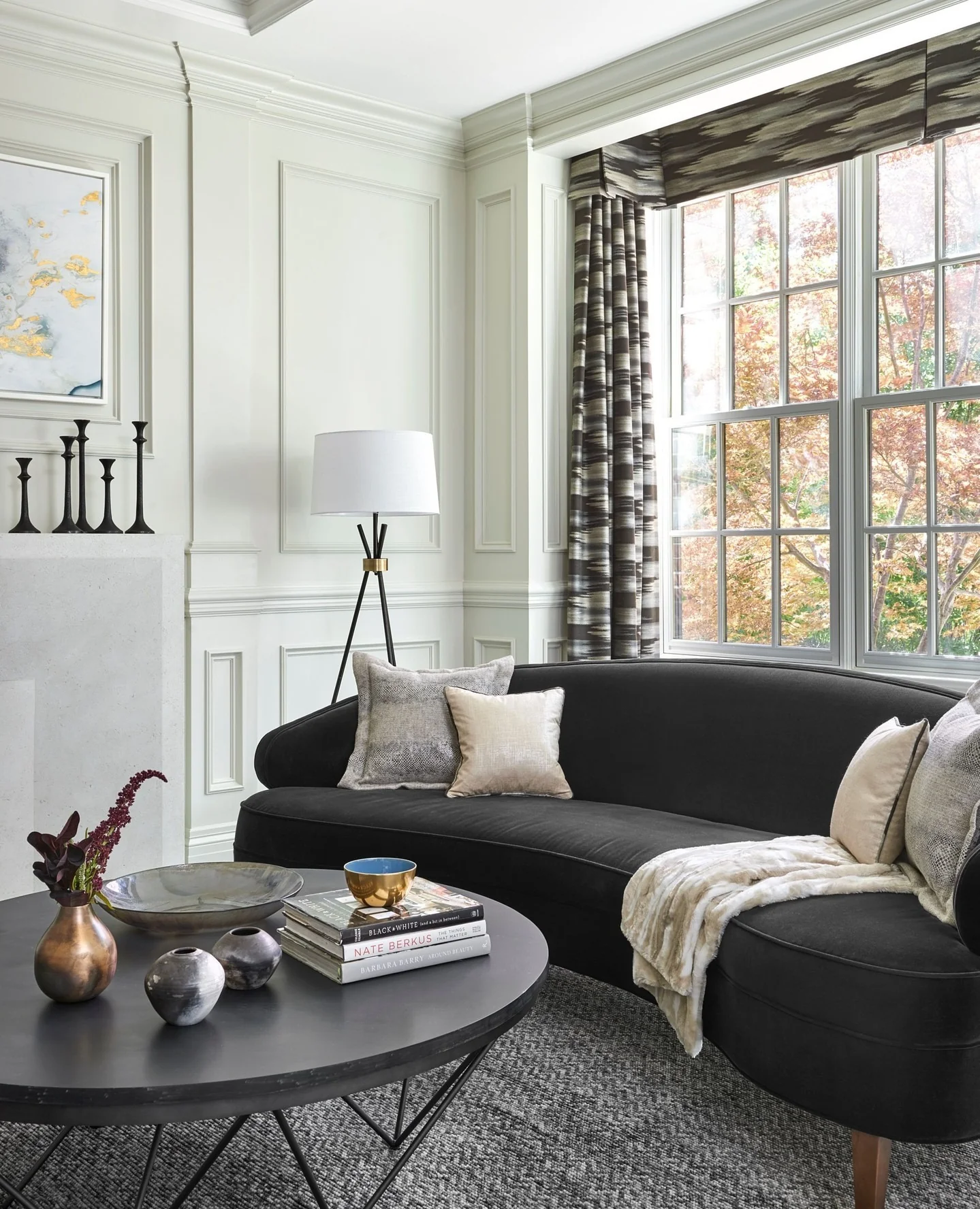Black Sofa With Patterned Throw Pillows and Blanket