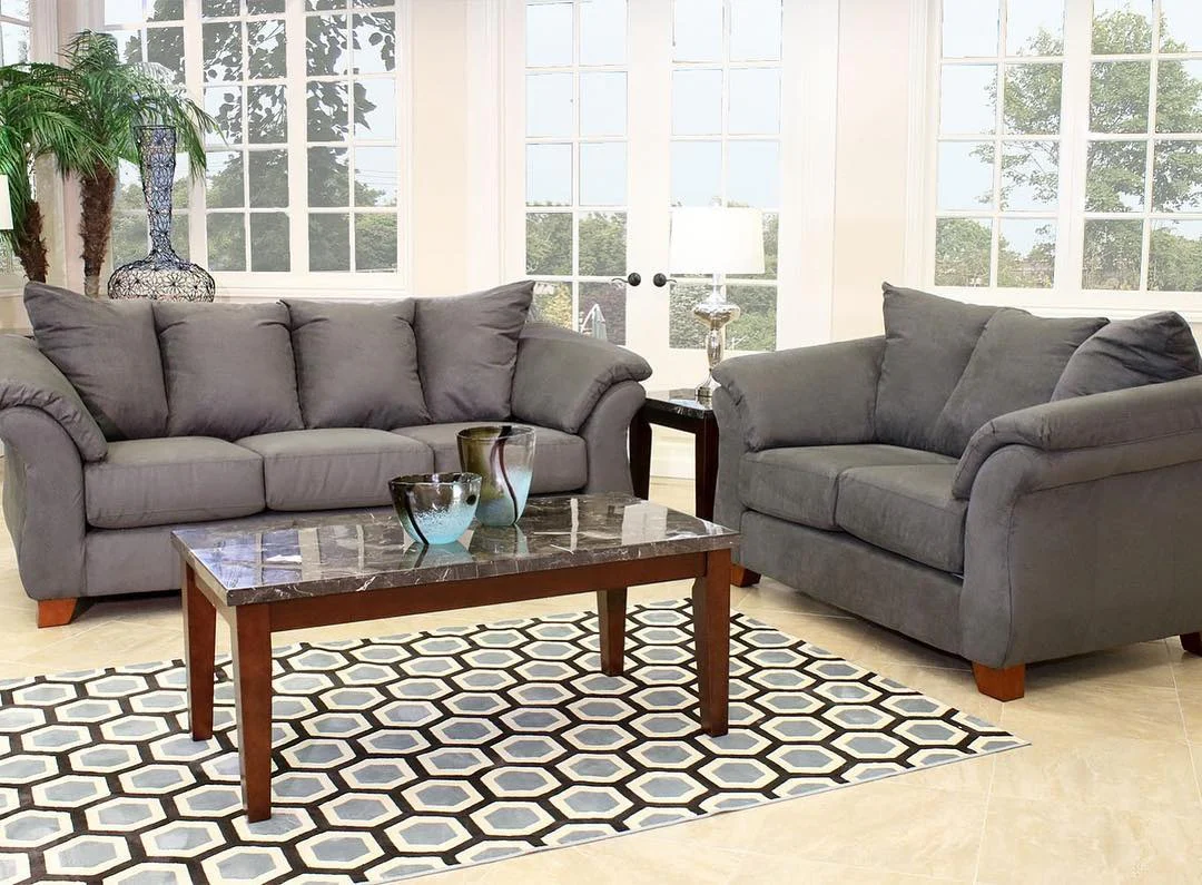 Geometric Rug Grounds Charcoal Sofas with Modern Flair