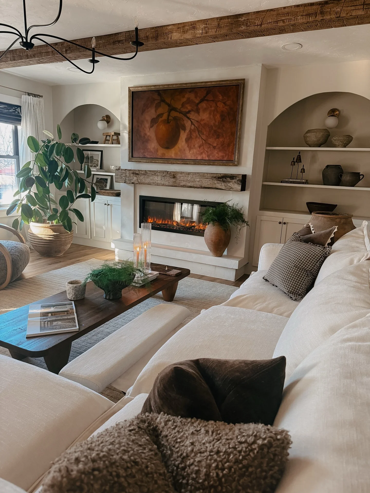 Tall Terra Cotta Vase Holds Ferns Next to Fireplace