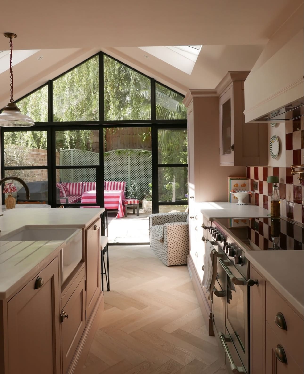 Checkerboard Tile Backsplash Adds Graphic Interest to Pink Cabinets