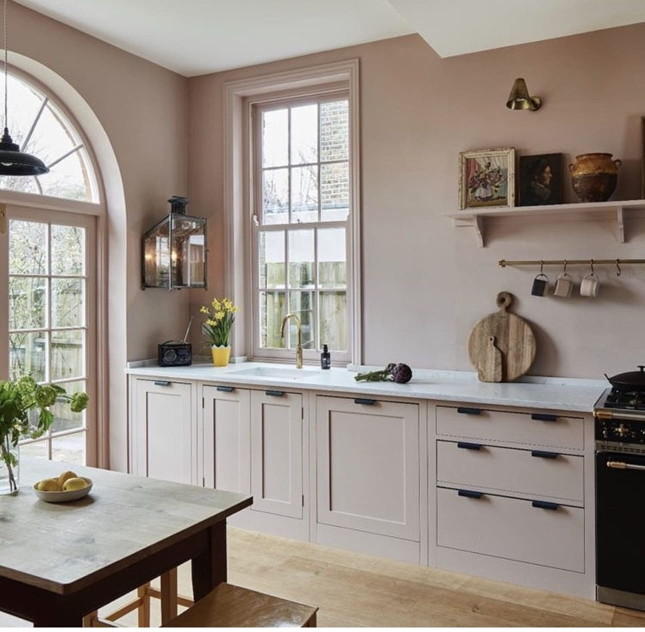 Shelf Display Adds Artful Charm Above Pink Kitchen Cabinets