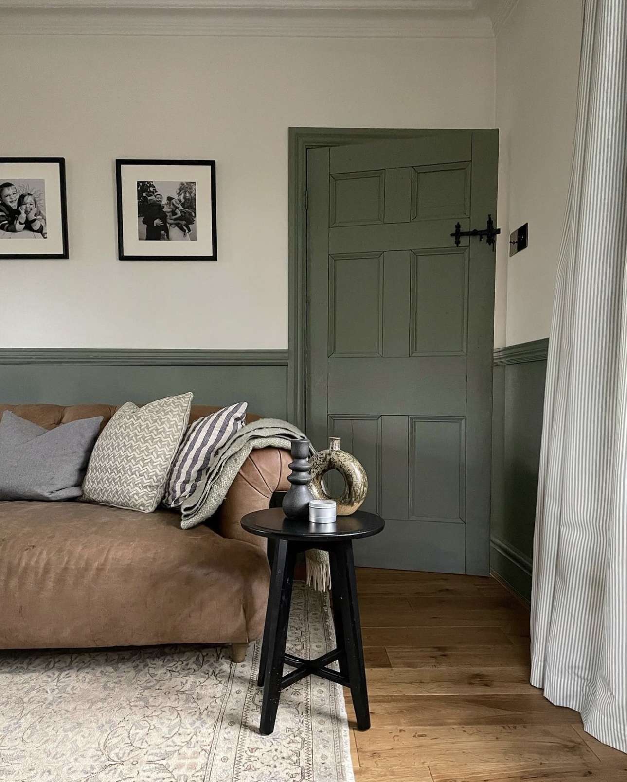 Sage Green Door With Black Hardware Creates a Moody Focal Point