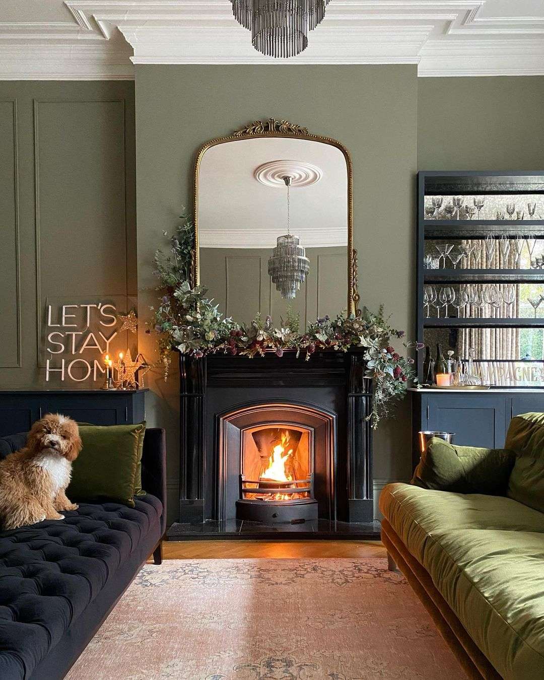 Ornate Gold Mirror Reflects A Luxurious Chandelier