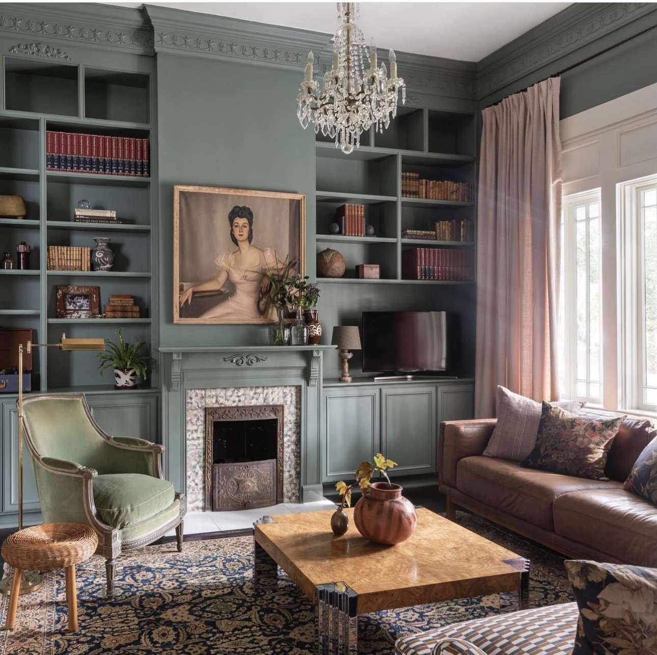 Sage Green Built-Ins Frame a Vintage Portrait Above the Fireplace
