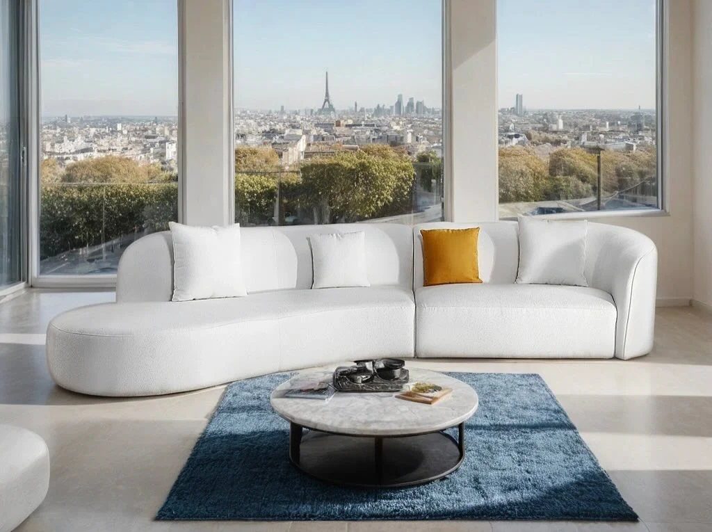 Rounded White Leather Sofa With a Single Ochre Pillow