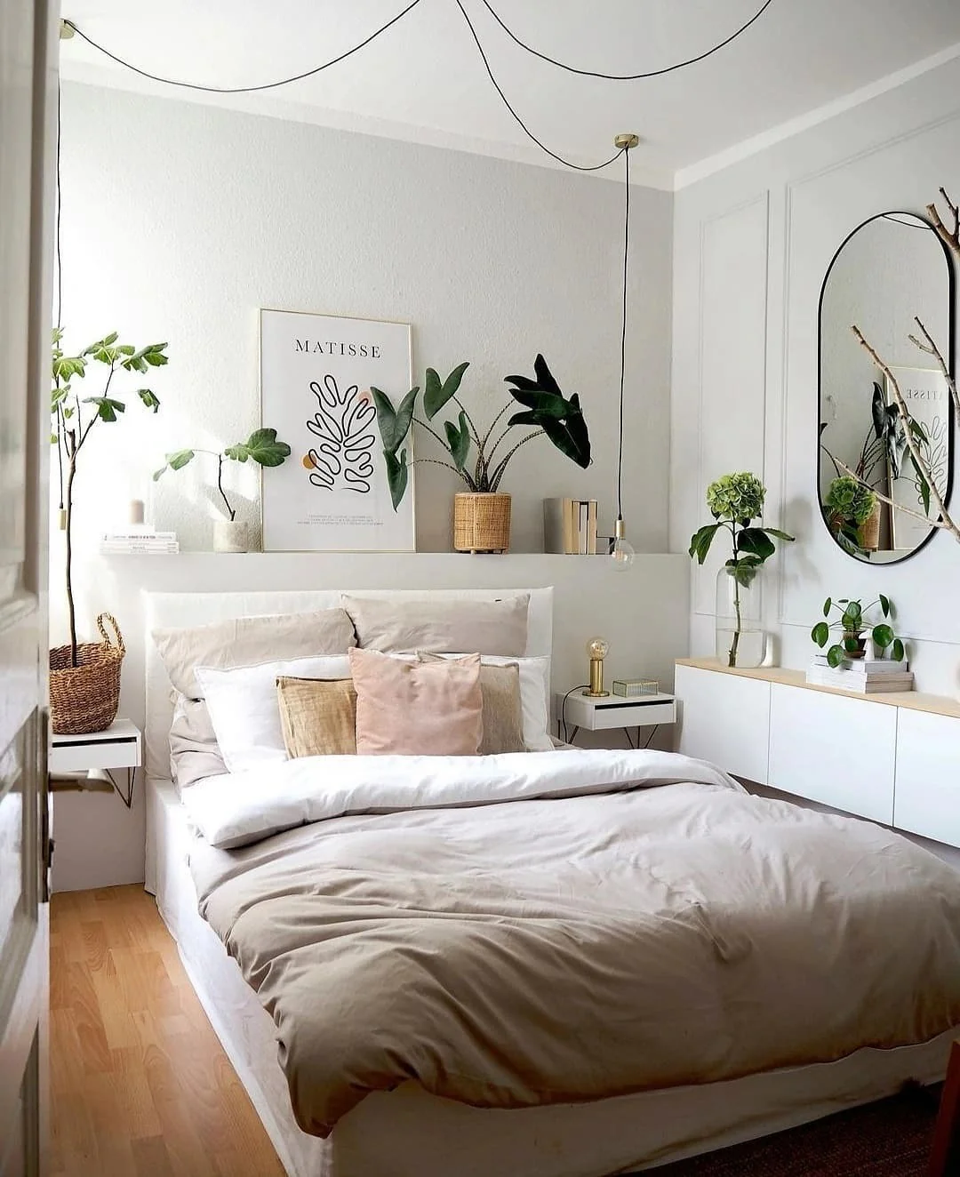 Floating bedside shelves hold plants and art