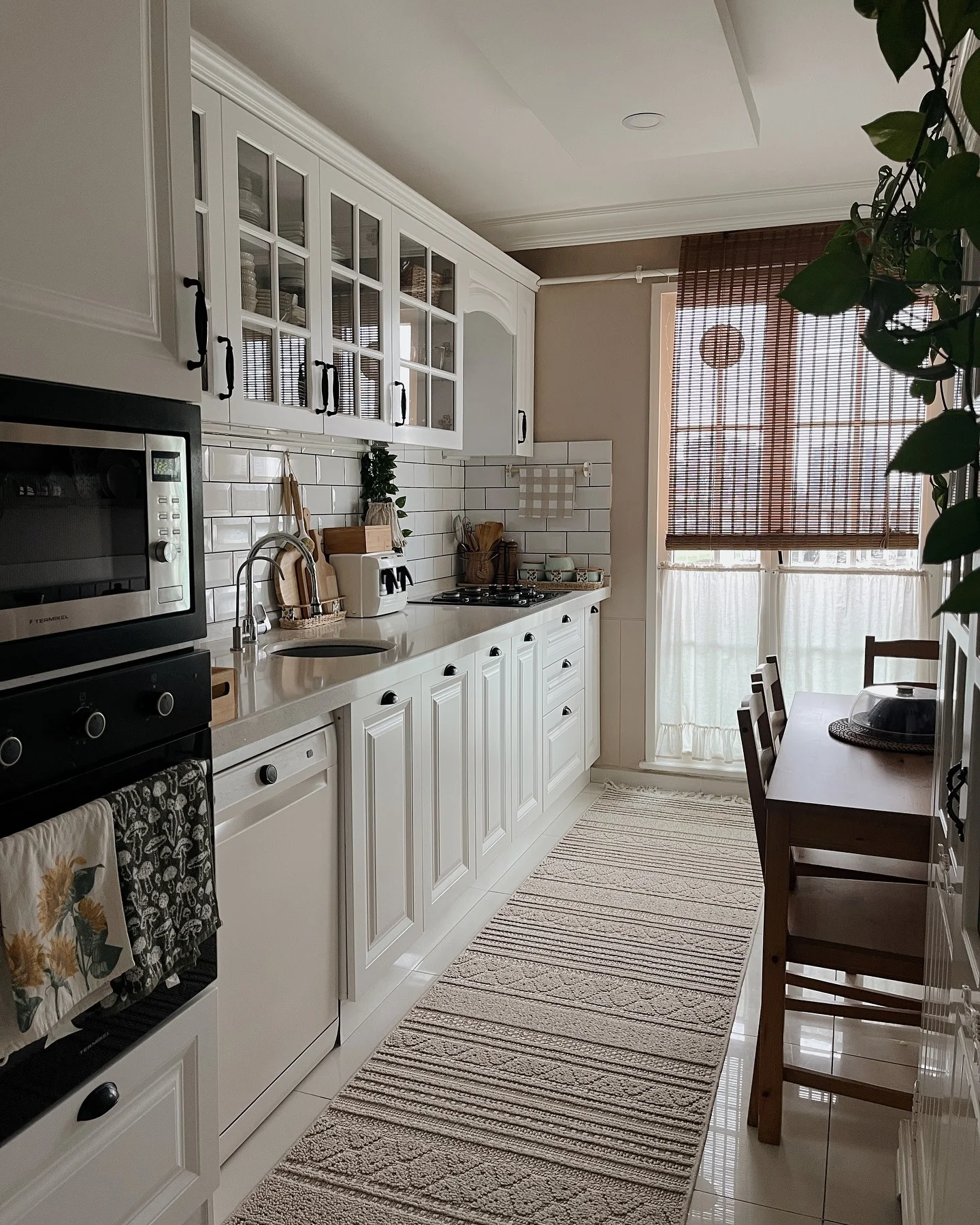 White Shaker Cabinets with Glass Panes Display Dishes