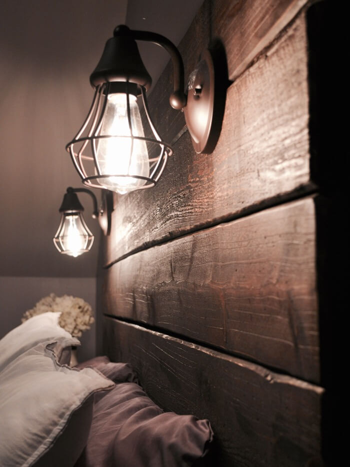 Illuminate a Dark Wood Headboard with Industrial Cage Sconces