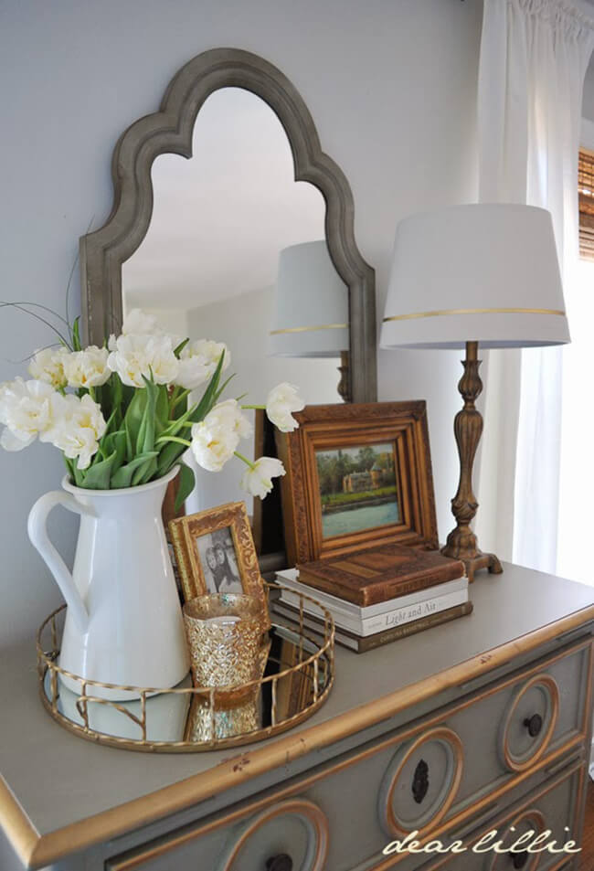 Ornate Mirror Frame Adds Architectural Interest Above Dresser