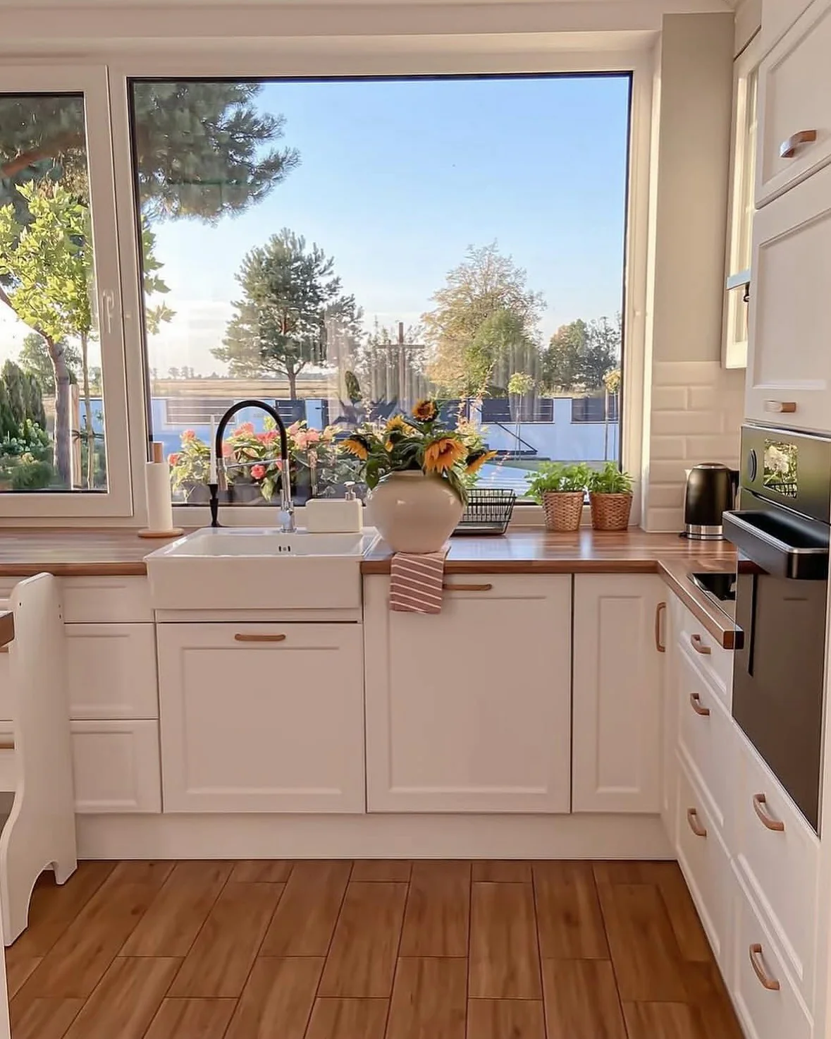 Sunflowers in a White Vase Add a Cheerful Touch to the Countertop