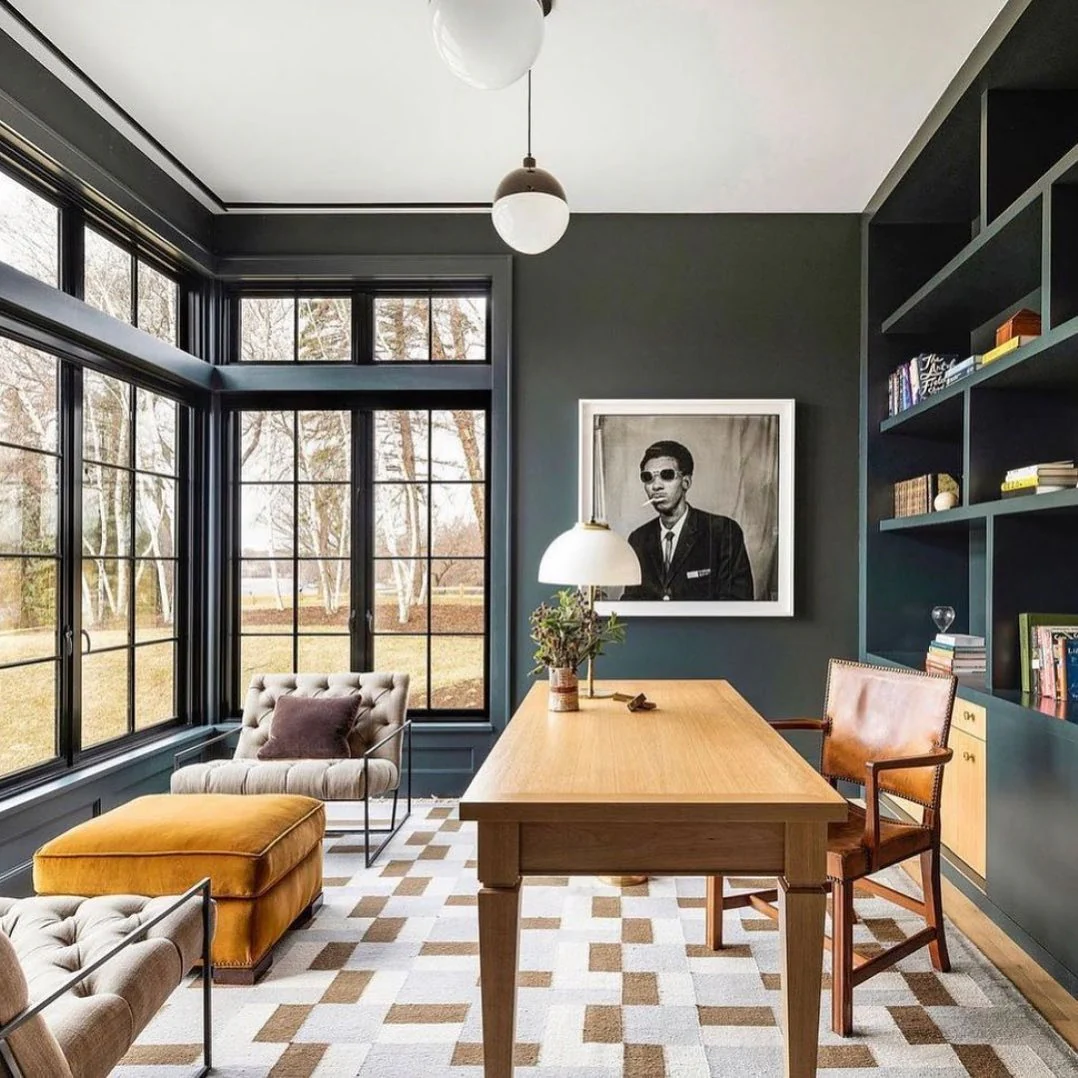 Dark Built-in Shelving Frames a Windowed Office Corner