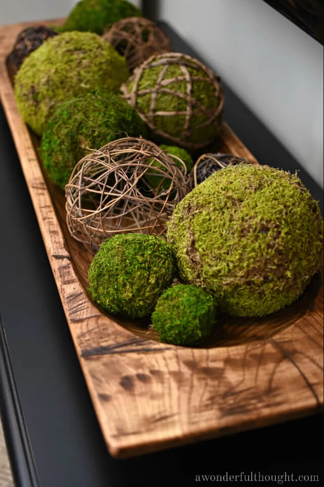 Moss and Twig Spheres in a Wooden Bowl