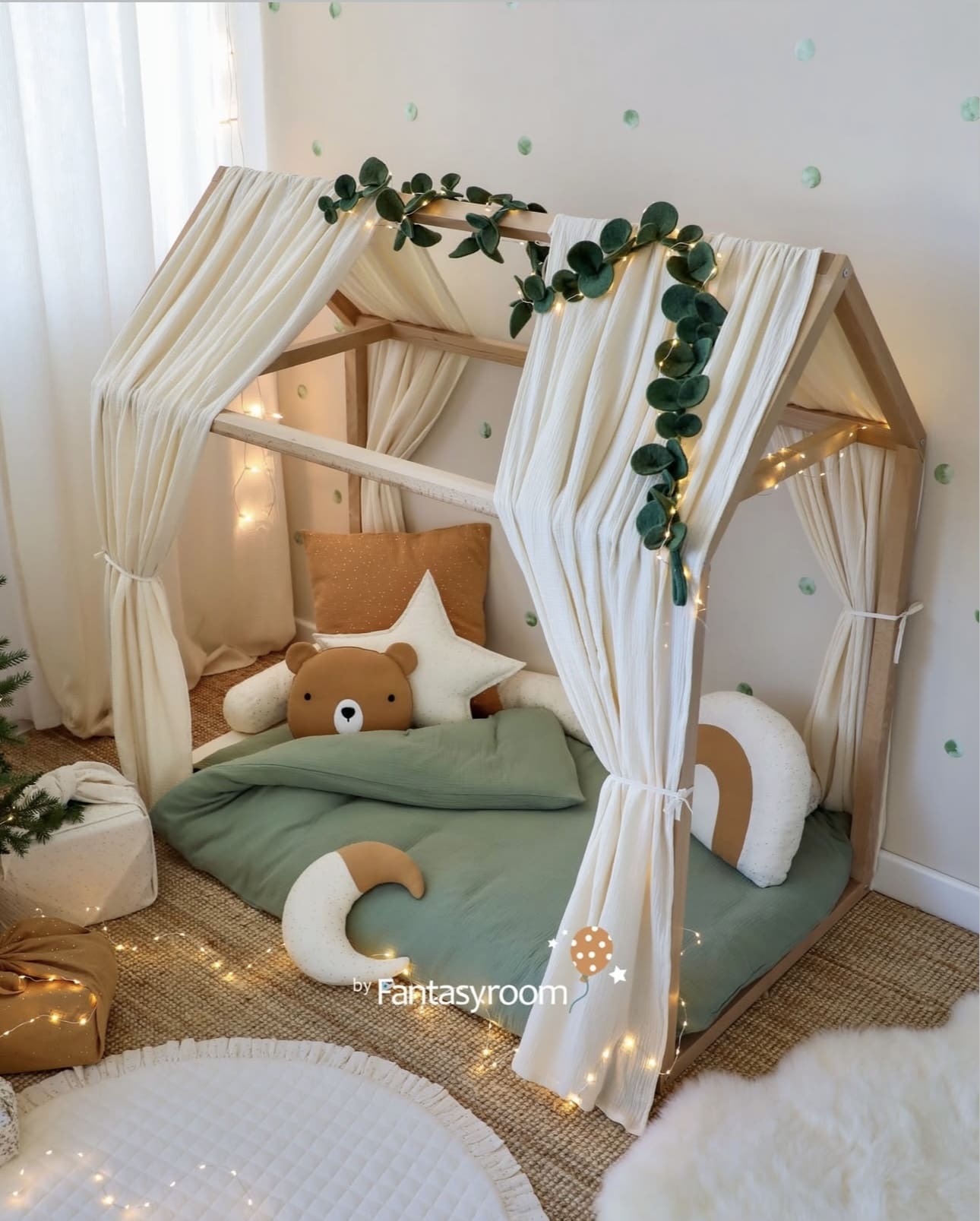Canopy Bed Frame Draped With Gauzy Curtains and Garland