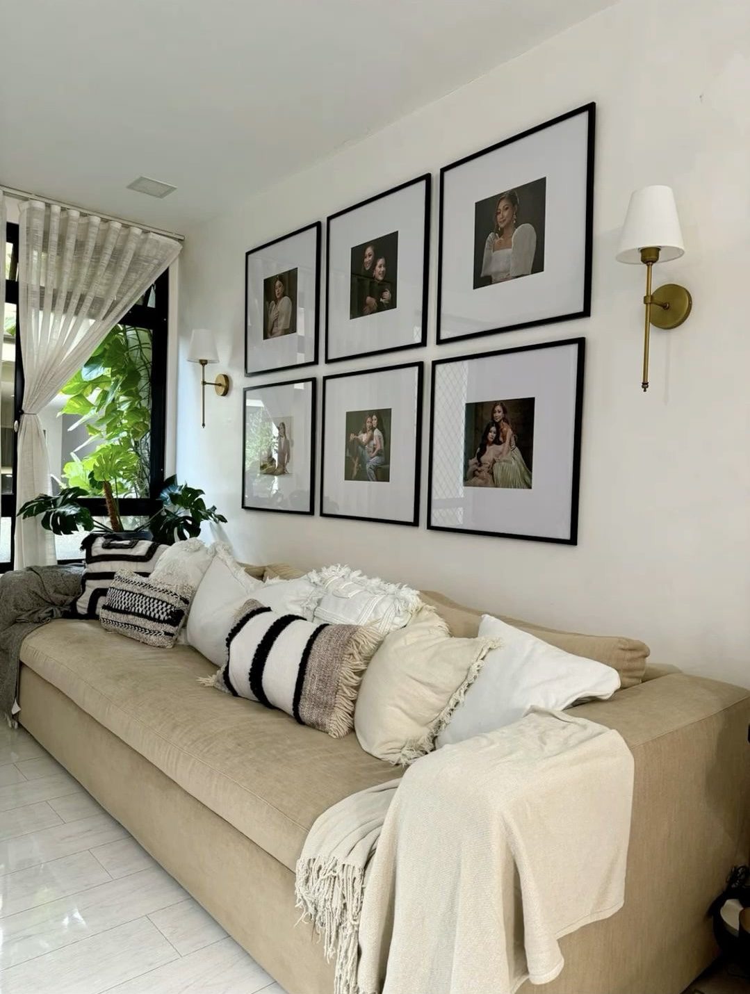 Six Identical Black Frames Create a Balanced Grid Above a Sofa