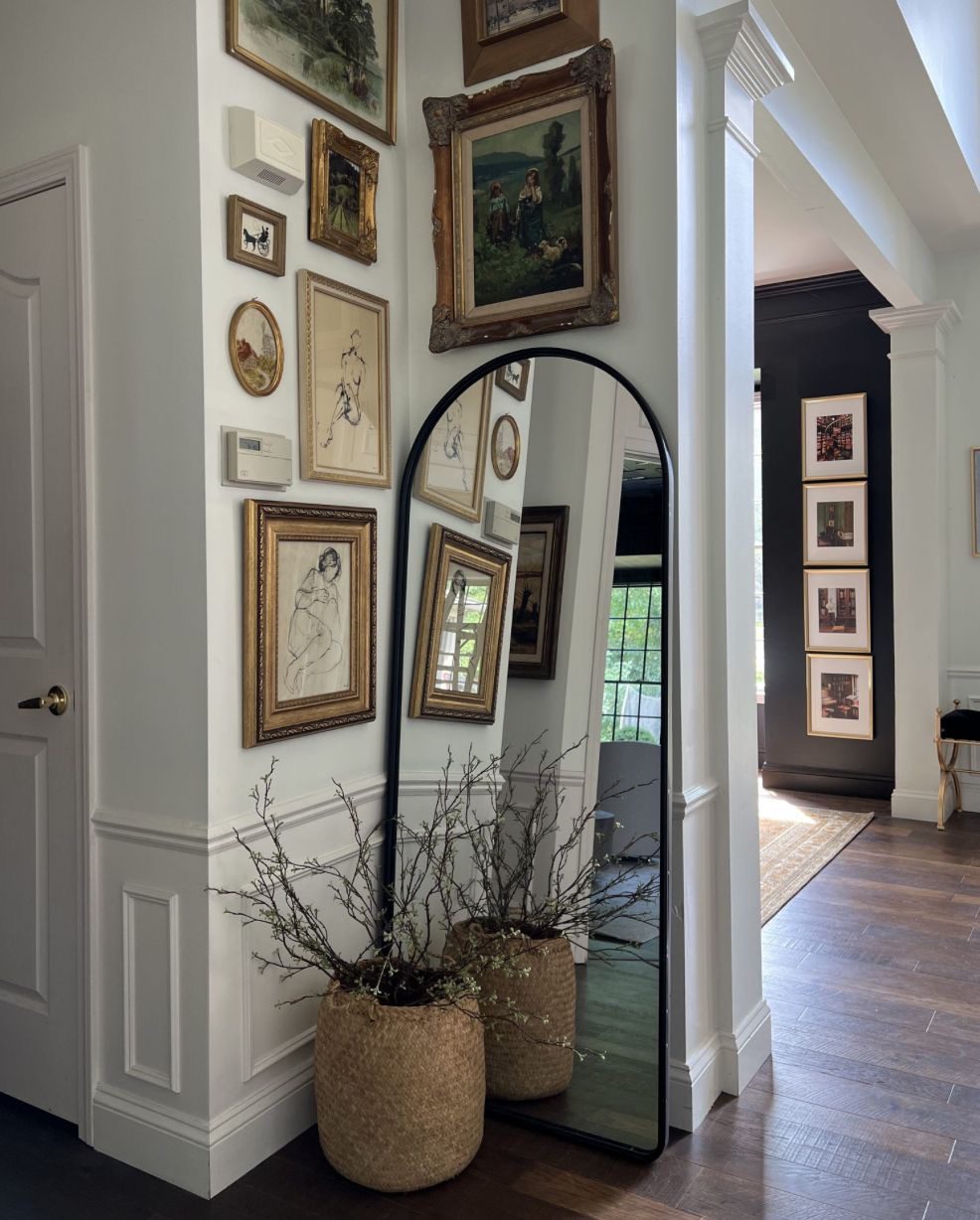 Arched Floor Mirror Reflects Gallery Wall