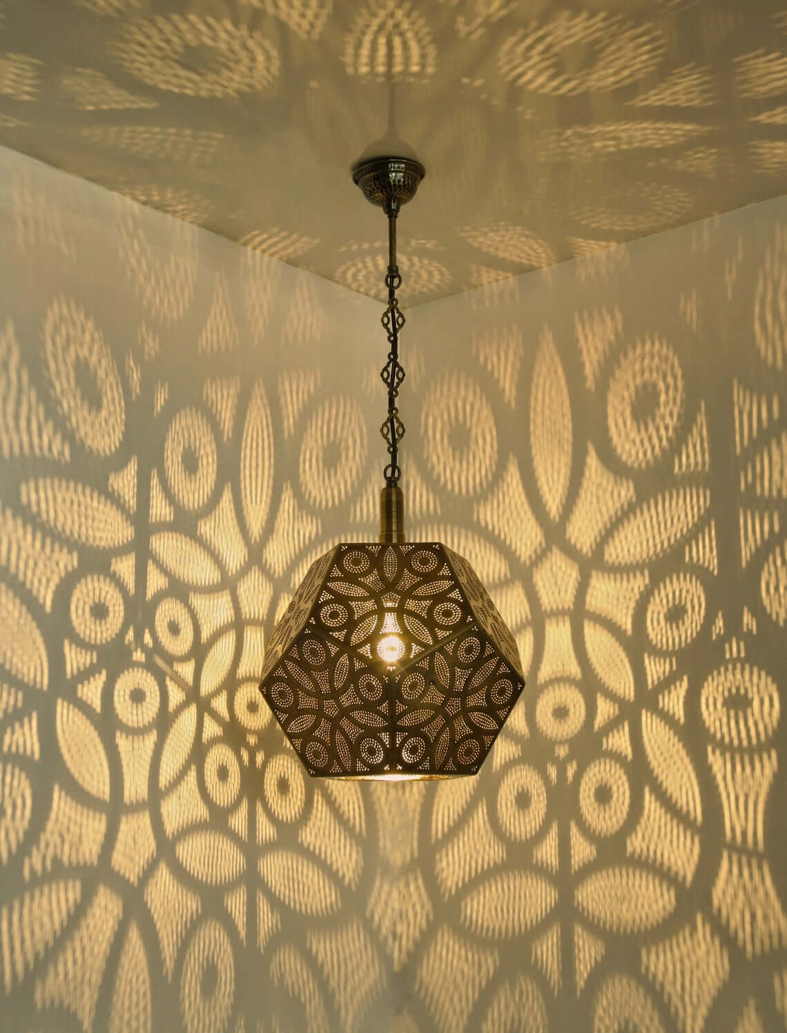 Geometric Metal Pendant Casts Intricate Shadow Patterns