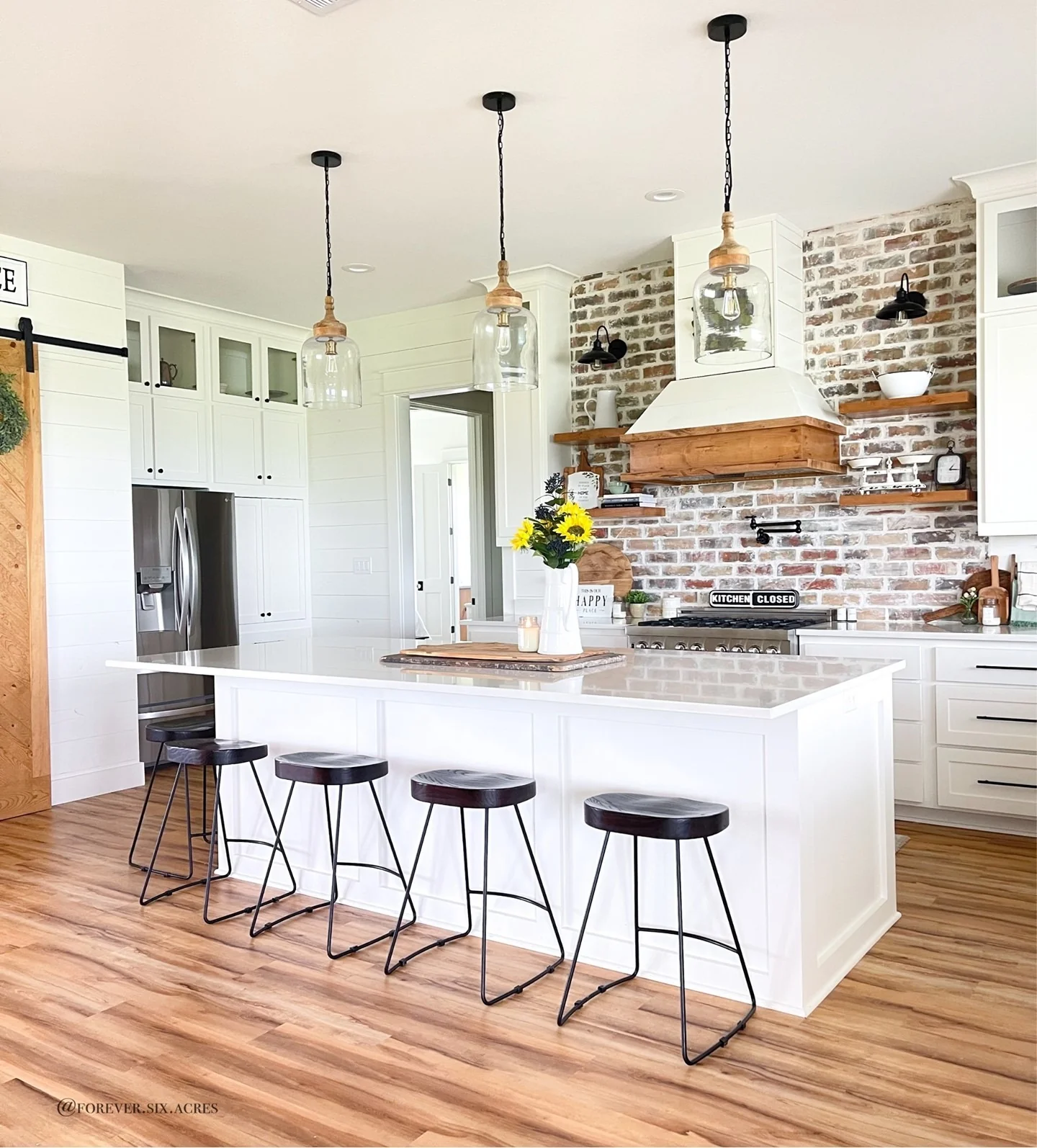 Wood-Accented Range Hood Above Brick