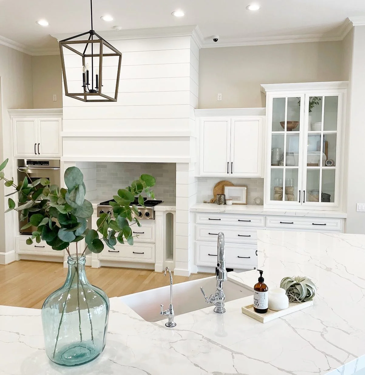 Frame Your Kitchen with Dark Hardware on Glass Cabinets