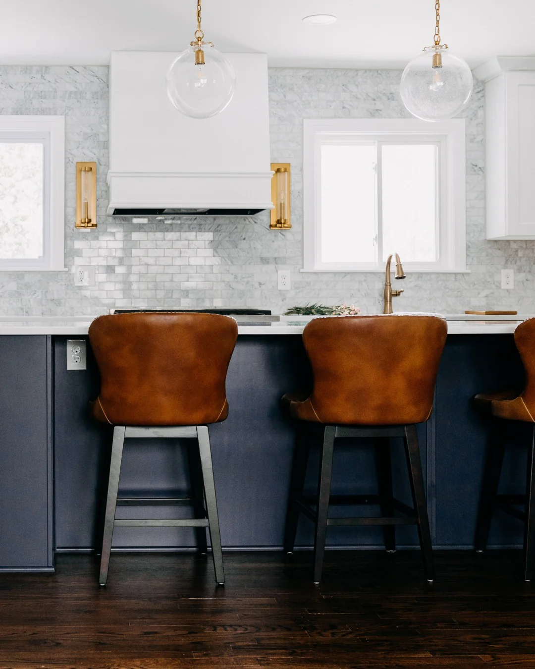 Contrast Dark Blue Island with an Intricate Marble Backsplash