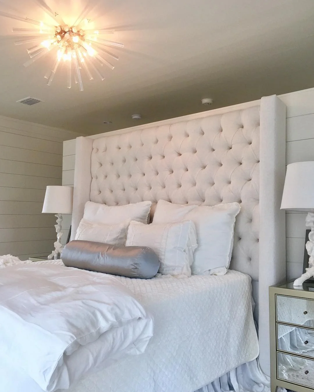 Floor-to-Ceiling Tufted Headboard Creates a Cozy Bedroom