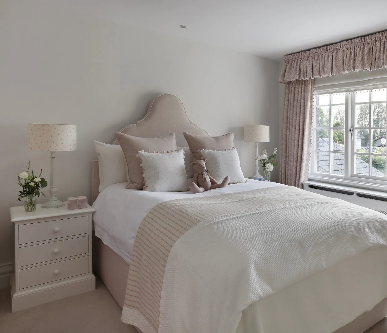 Curved Headboard Upholstered in Soft Blush Fabric