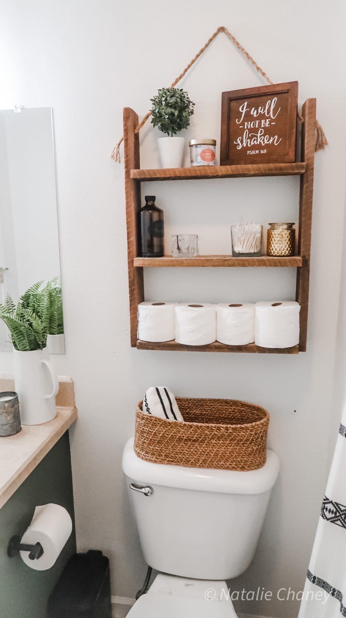 Wooden Shelf Above Toilet Holds Toilet Paper Rolls