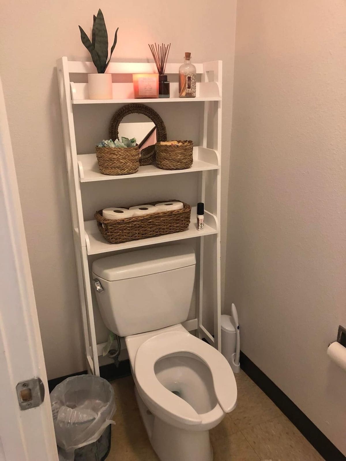 Tiered Shelf Unit Adds Vertical Storage Above Toilet