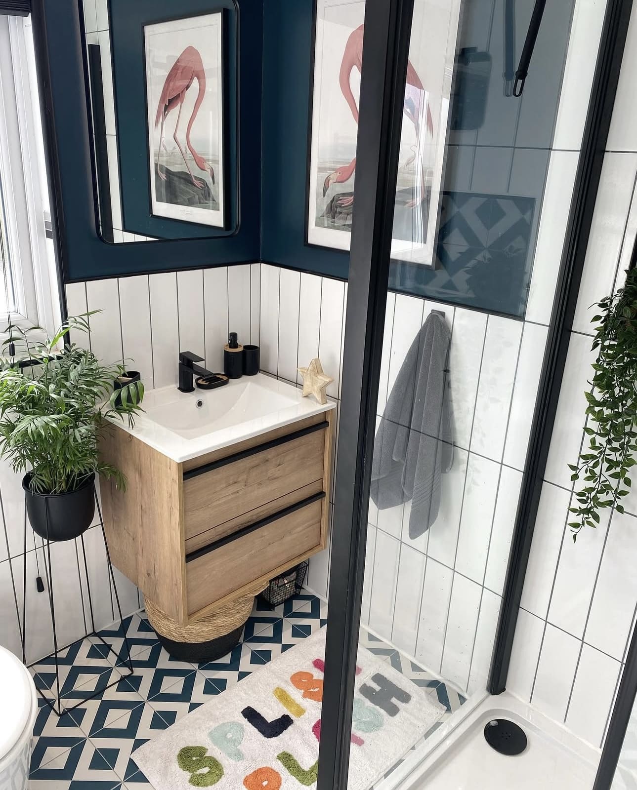 Wood-Tone Vanity With Black Hardware Adds Warmth to Small Bath