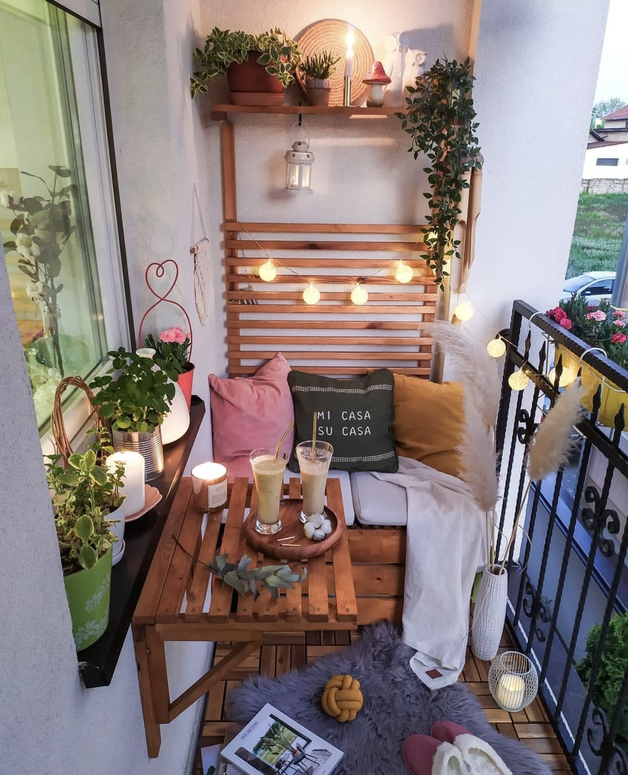 String lights add a cozy glow to the wooden slat bench