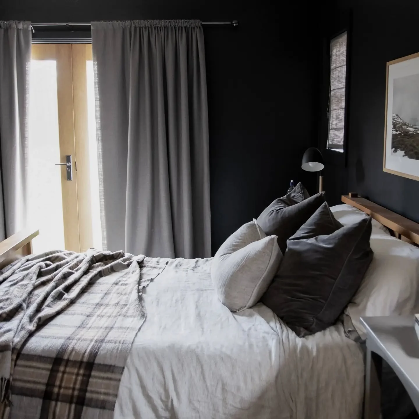 Layer Plush Pillows for Cozy Contrast on Black Walls