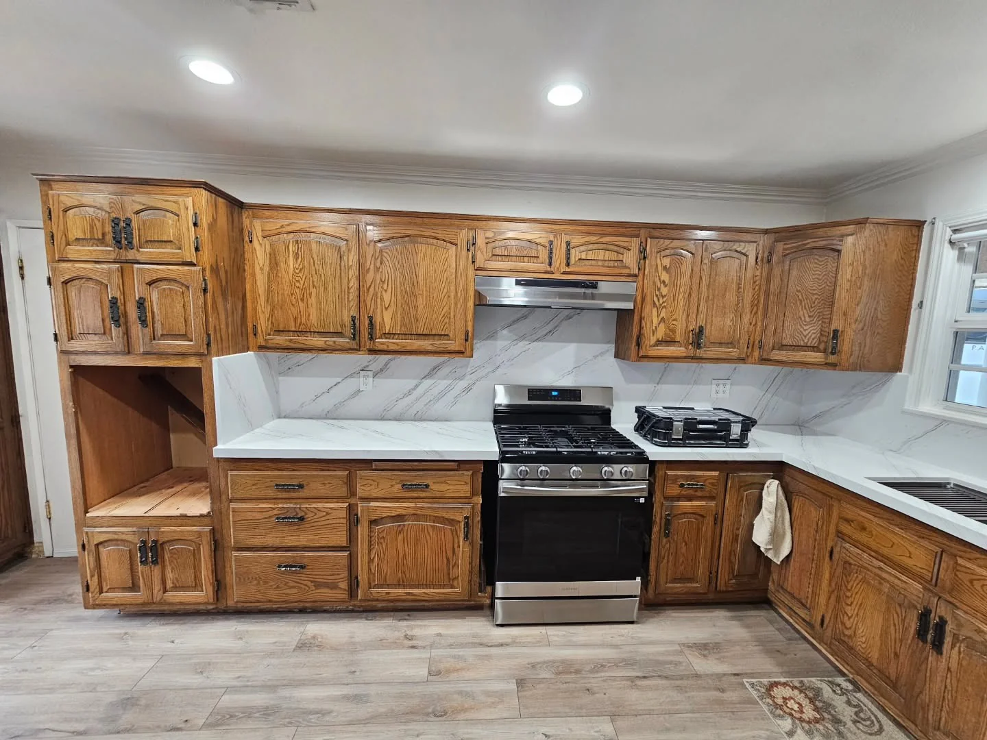 Warm Wood Base Cabinets with Black Hardware