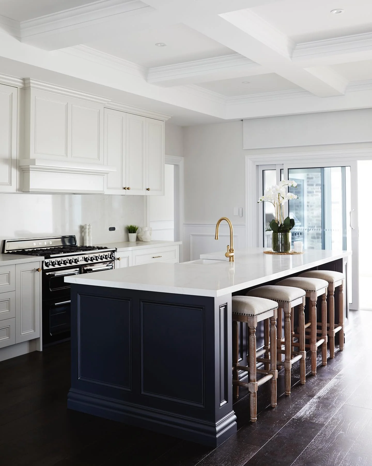 Dark Navy Island Adds Rich Contrast to White Perimeter Cabinets
