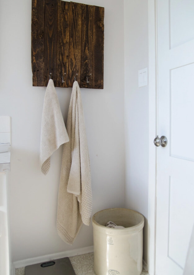 Dark Wood Plank Wall With Hooks for Towels